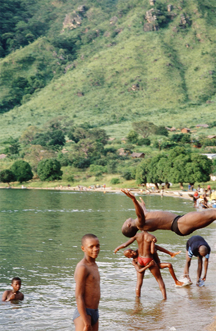 Local people bathing and washing clothes, pans etc. at the waterfront, Metangula, Mozambique: this is a prime risk location for schistosomiasis (bilharzia) transmission